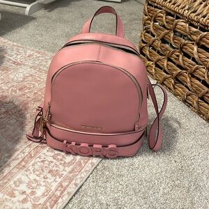 Pink Micheal Kors backpack. Only used a few times. No pen marks.